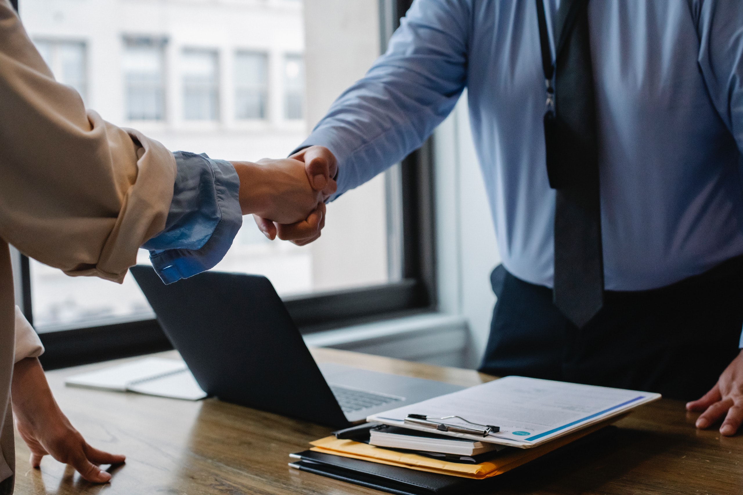 Colleagues shaking hands in office