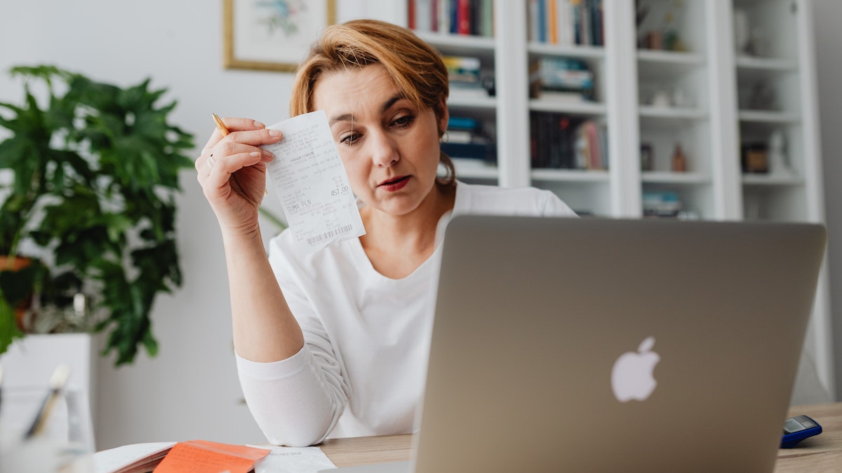 Woman calculating her receipts.