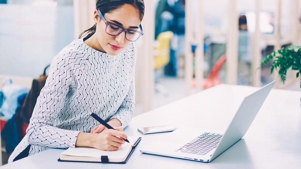 A woman writing proposal